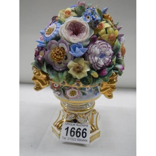 1666 - A Derby vase of flowers on ornate base.