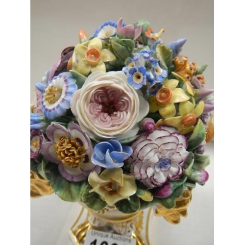 1666 - A Derby vase of flowers on ornate base.