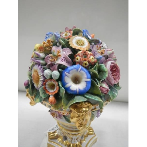 1666 - A Derby vase of flowers on ornate base.