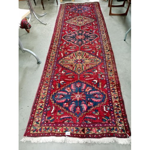 1698 - A long carpet runner, fabulous colours including navy, red, pink. Size approximately 325 x 103cm