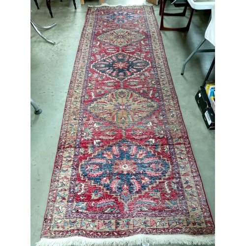 1698 - A long carpet runner, fabulous colours including navy, red, pink. Size approximately 325 x 103cm