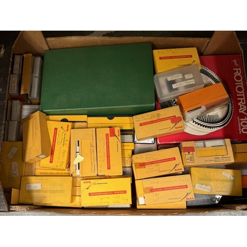 1694 - A box of slides and a slide magazine