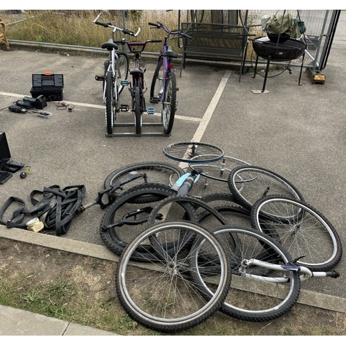 1873 - Three bicycles with a large quantity of spare wheels, tyres & a box of tools