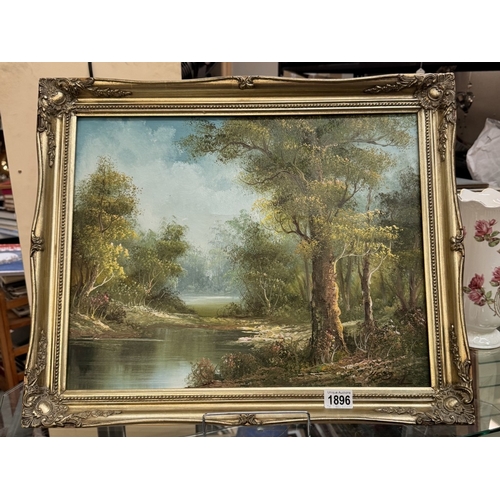 1896 - A gilt framed oil on canvas of a wooded lake