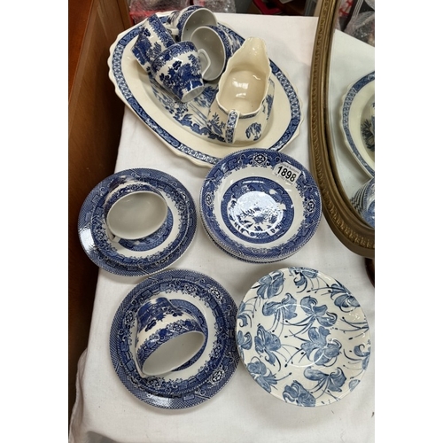 1898 - A quantity of blue & white in willow pattern china