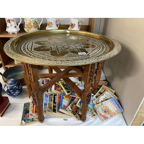 1602 - A Middle Eastern brass tray topped table