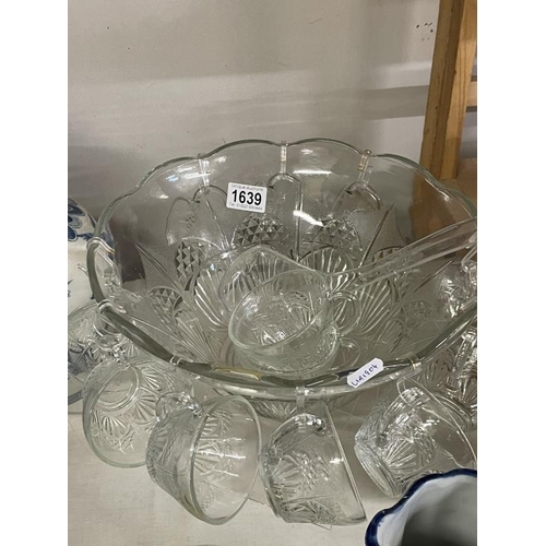 1639 - A glass punch bowl with 10 attached glass cups & ladle