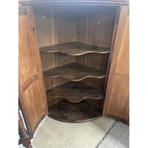 1689 - A mahogany bow fronted wall mounting corner cupboard, COLLECT ONLY.