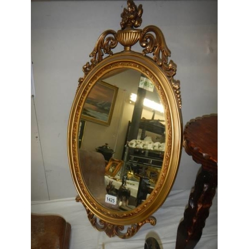 1425 - A gilt framed oval mirror. COLLECT ONLY.