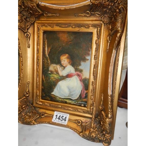 1454 - A gilt framed enhanced print of a child with a rabbit.