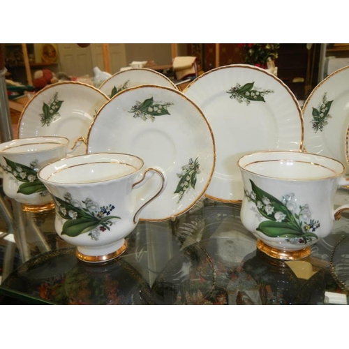 1455 - A bone china tea set decorated with lily of the valley. COLLECT ONLY.