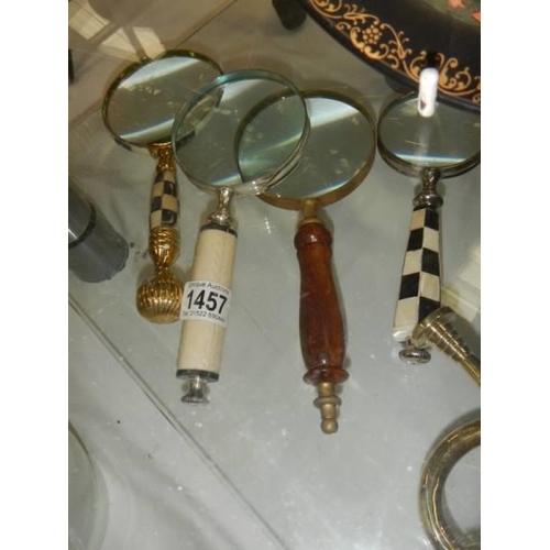 1457 - Four assorted magnifying glasses.