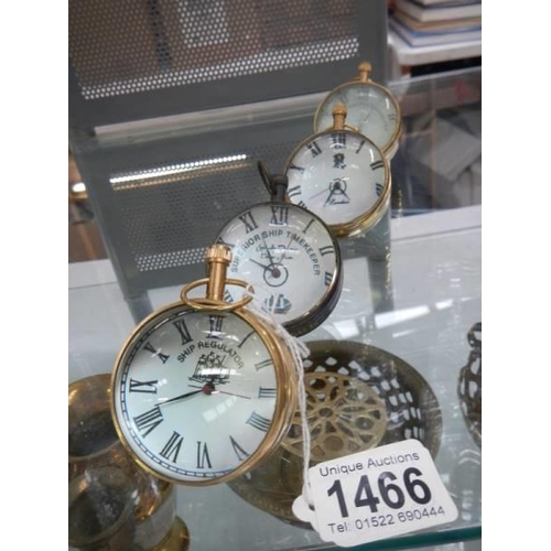 1466 - Four globe shaped desk clocks.