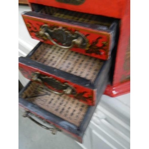 1484 - A 20th century copy of a Japanese red lacquered jewellery case hand painted with birds.