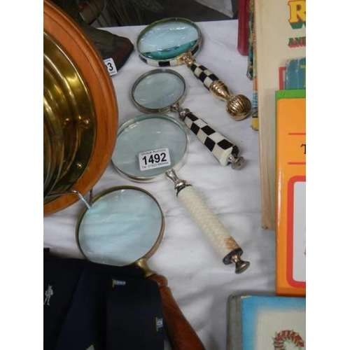 1492 - Four assorted magnifying glasses.