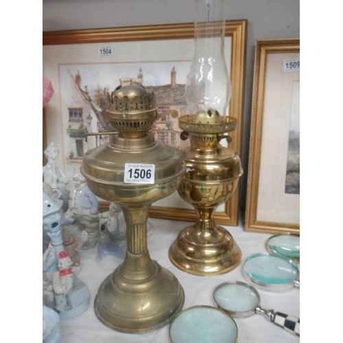 1506 - Two old brass oil lamps.