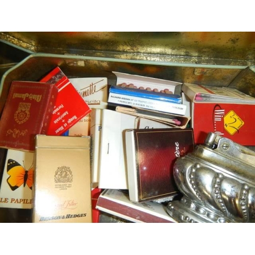 1594 - A mixed lot including lighter, match books etc.,