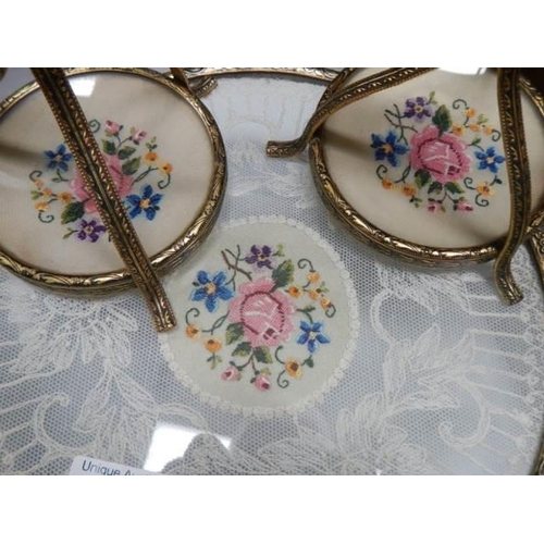 1629 - A vintage dressing table tray with lace inset and a pair of candlesticks.