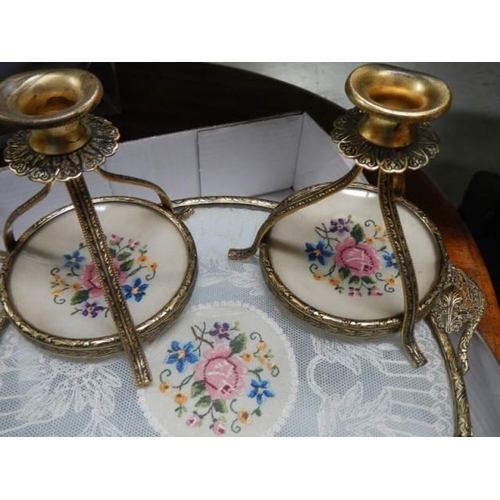 1629 - A vintage dressing table tray with lace inset and a pair of candlesticks.