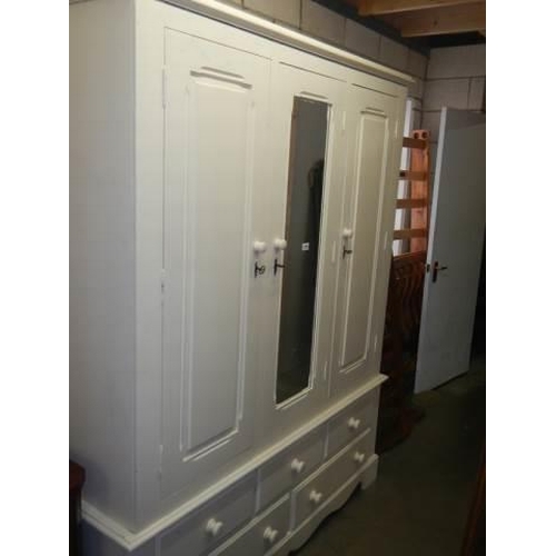 1710 - A good painted pine three door wardrobe on drawer base. COLLECT ONLY.