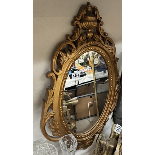 1444 - An oval gilt framed mirror. COLLECT ONLY.