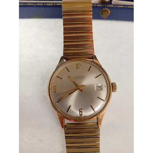 1007 - A gold Garrard automatic date watch with gold coloured strap in Garrard box