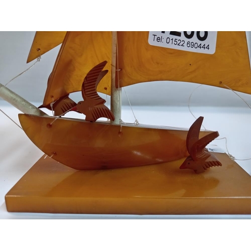 1288 - An Amber Bakelite yacht / boat with seabirds