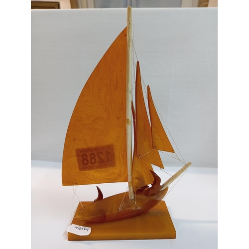 1288 - An Amber Bakelite yacht / boat with seabirds