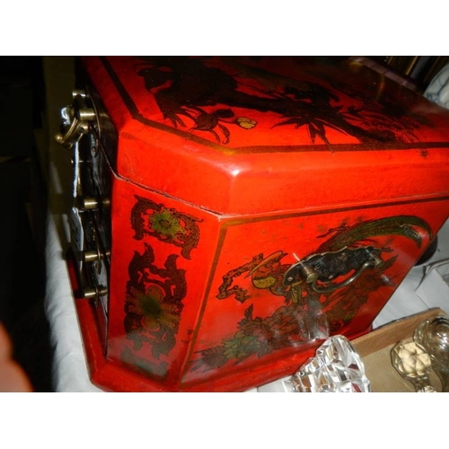 701 - A good quality Japanese style red lacquered jewellery casket.