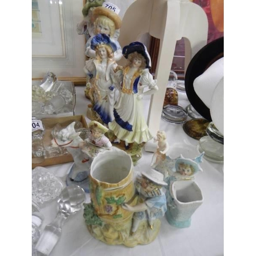 705 - A good lot of continental porcelain figurines.