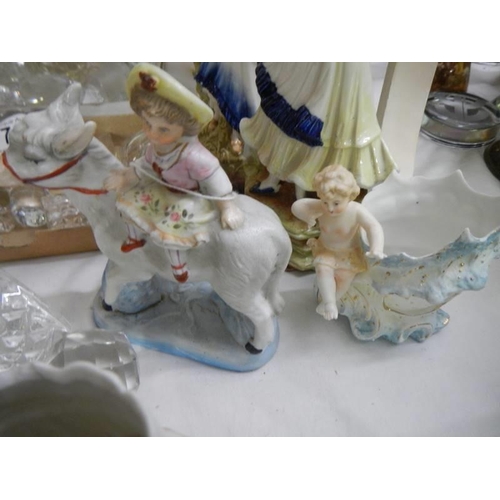 705 - A good lot of continental porcelain figurines.