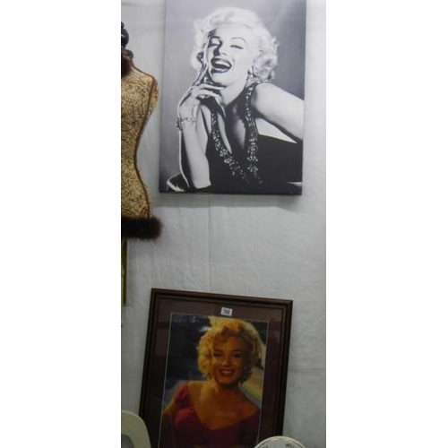 708 - A framed and glazed photograph of Marylin Monroe and one on canvas, COLLECT ONLY.