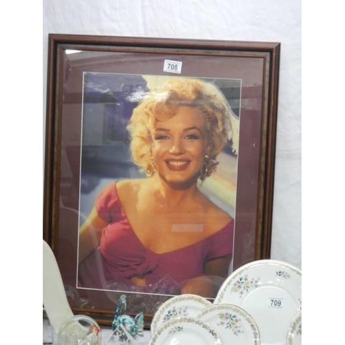 708 - A framed and glazed photograph of Marylin Monroe and one on canvas, COLLECT ONLY.