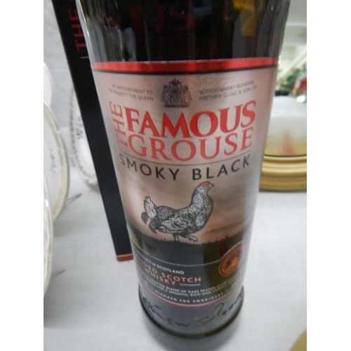 712 - A boxed bottle of Famouse Grouse whisky.