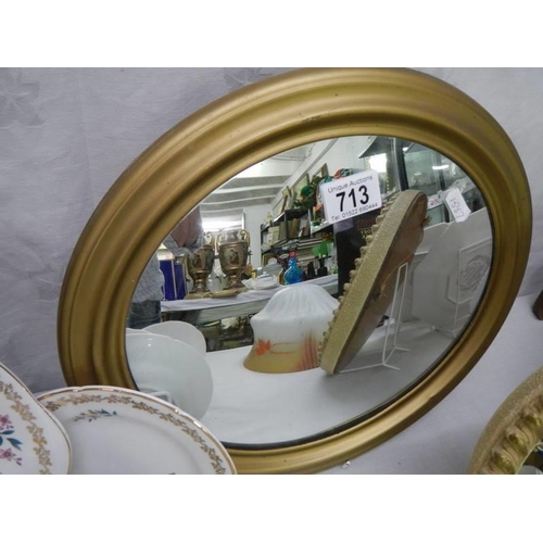 713 - Two small oval gilt framed mirrors, COLLECT ONLY.