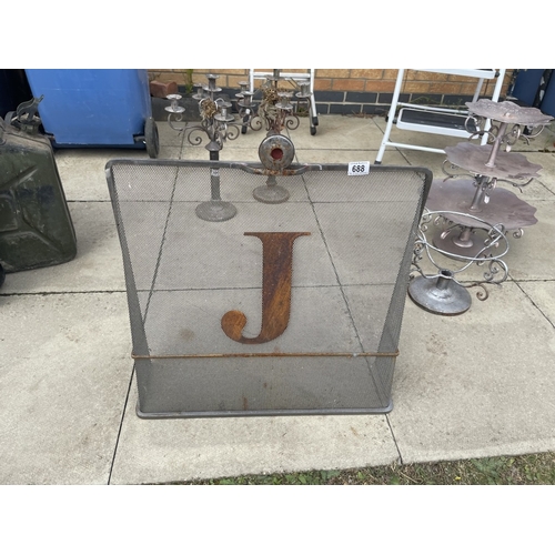 688 - A vintage metal fire guard with letter J