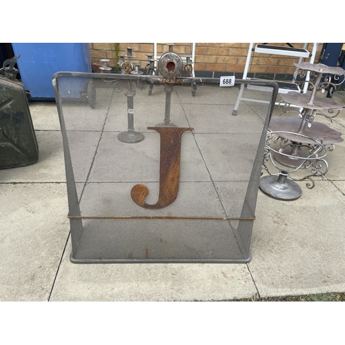 688 - A vintage metal fire guard with letter J