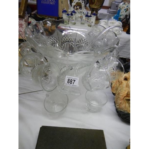 887 - A large glass punch bowl with cups and a plastic ladle. COLLECT ONLY.