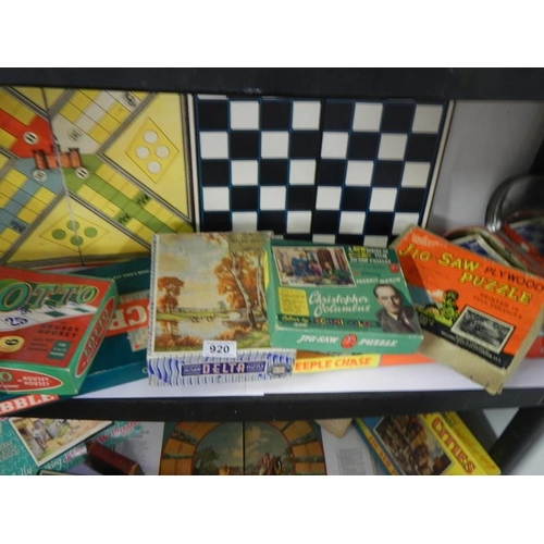 920 - Two shelves of assorted vintage games and puzzles.