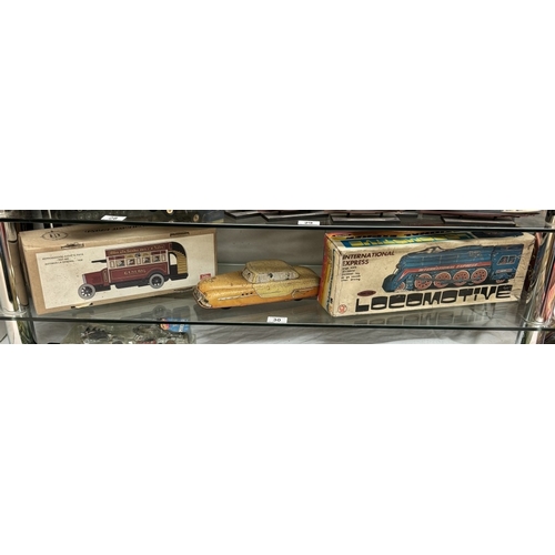 30 - A boxed international express locomotive, Paya clockwork tinplate bus & A large Mettoy tin lithograp... 