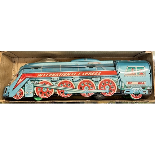 30 - A boxed international express locomotive, Paya clockwork tinplate bus & A large Mettoy tin lithograp... 