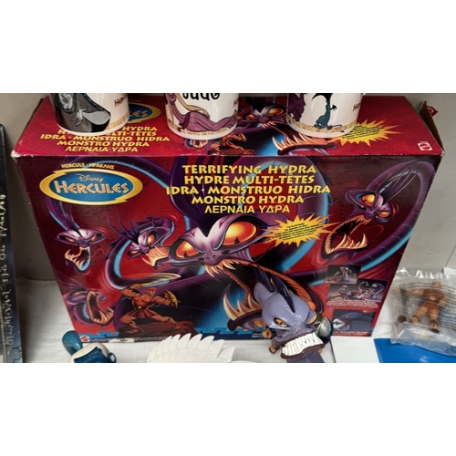 35 - A boxed Disney Hercules Terrifying Hydra, A quantity of loose figures, Three new mugs & A new T-Shir... 