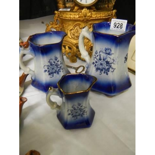 928 - A set of three graduated blue and white Staffordshire jugs.