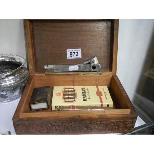 972 - A cigar box with cigar cutter, cigars etc.,