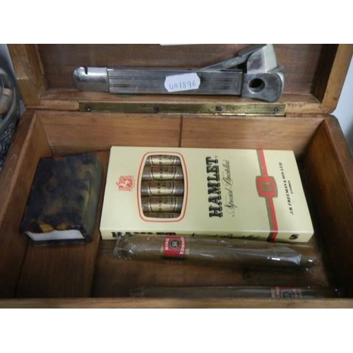 972 - A cigar box with cigar cutter, cigars etc.,