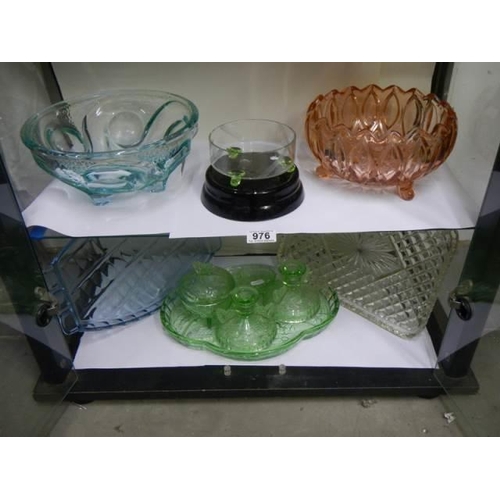 976 - Two shelve of assorted coloured glass etc.,