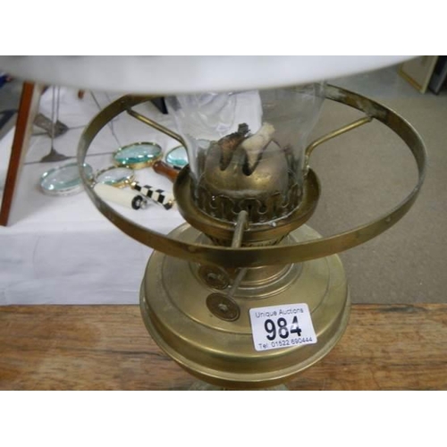 984 - An early 20th century brass oil lamp complete with shade, COLLECT ONLY.