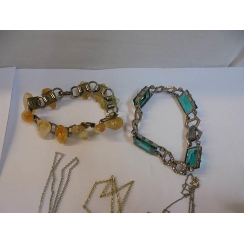 1032 - A crystal pendant on silver chain, two jade pendants, 2 other pendants and 2  bracelets.