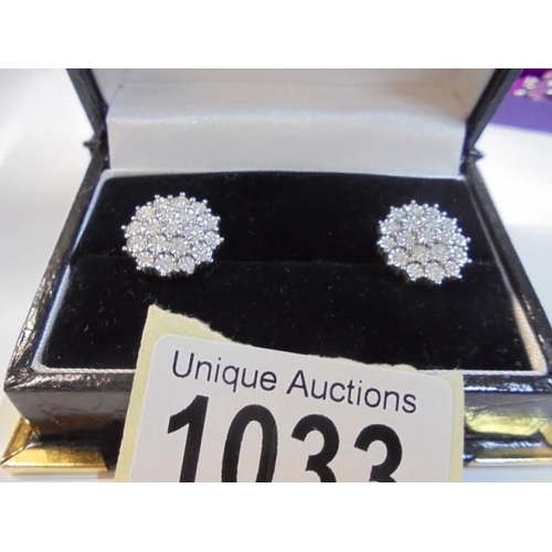 1033 - A pair of white 9ct gold fine diamond earrings (total weight 5 grams).