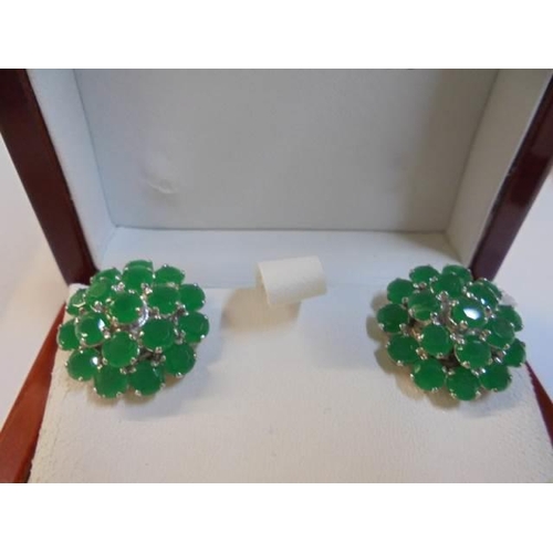 1034 - A pair of silver and emerald earrings.